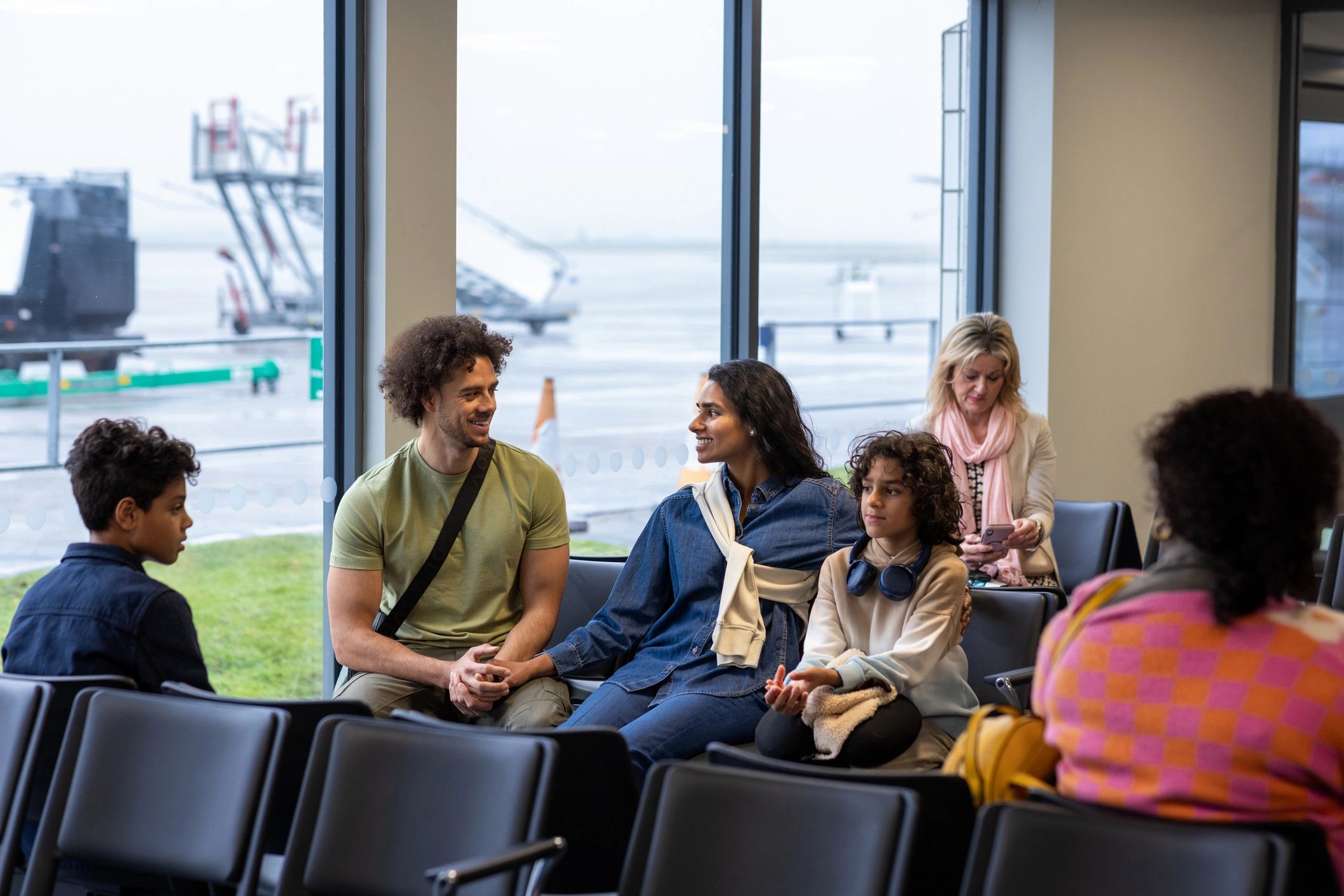 Group of travelers waiting together at an airport lounge