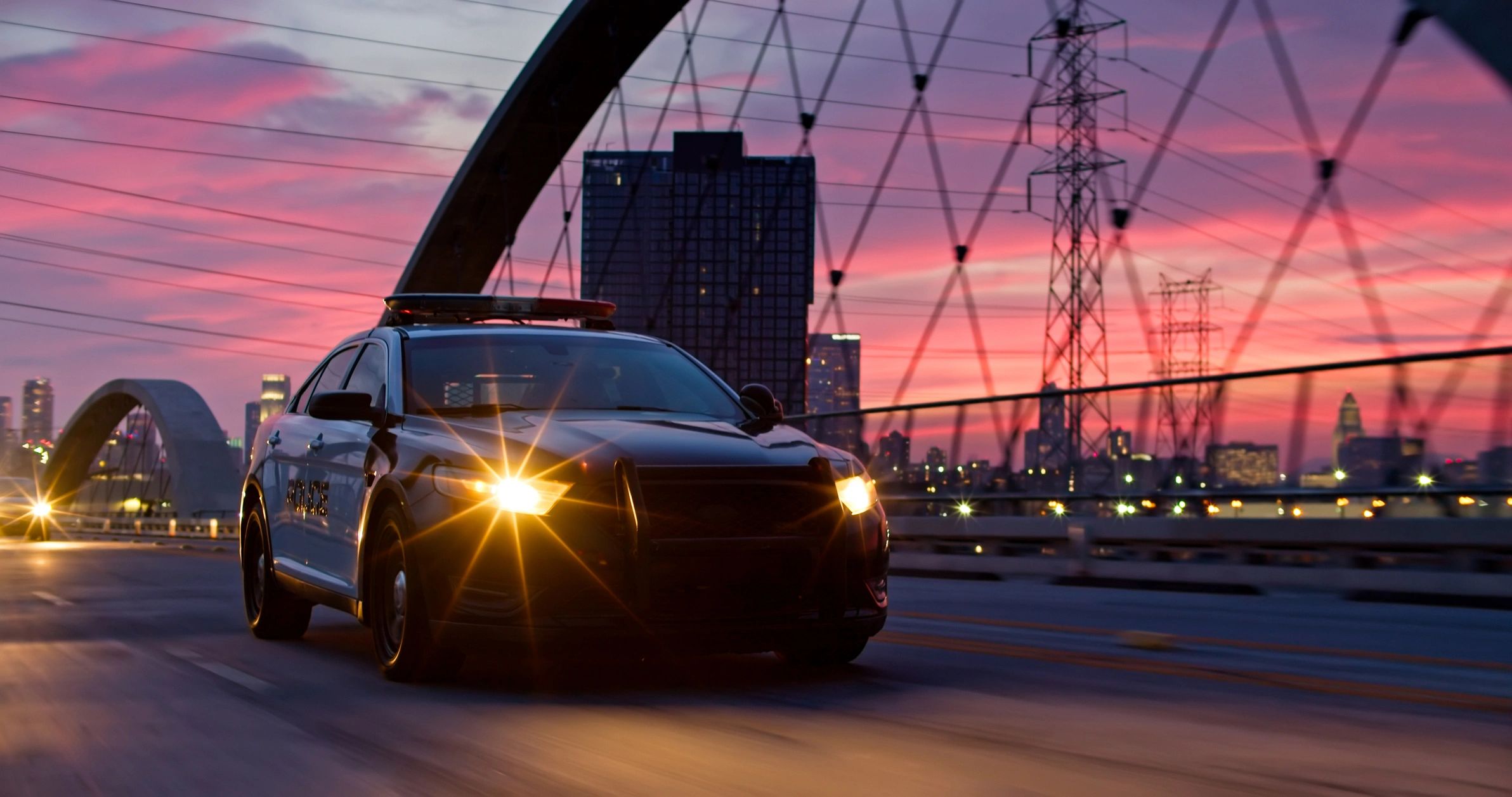 Vehicle on bridge at sunset