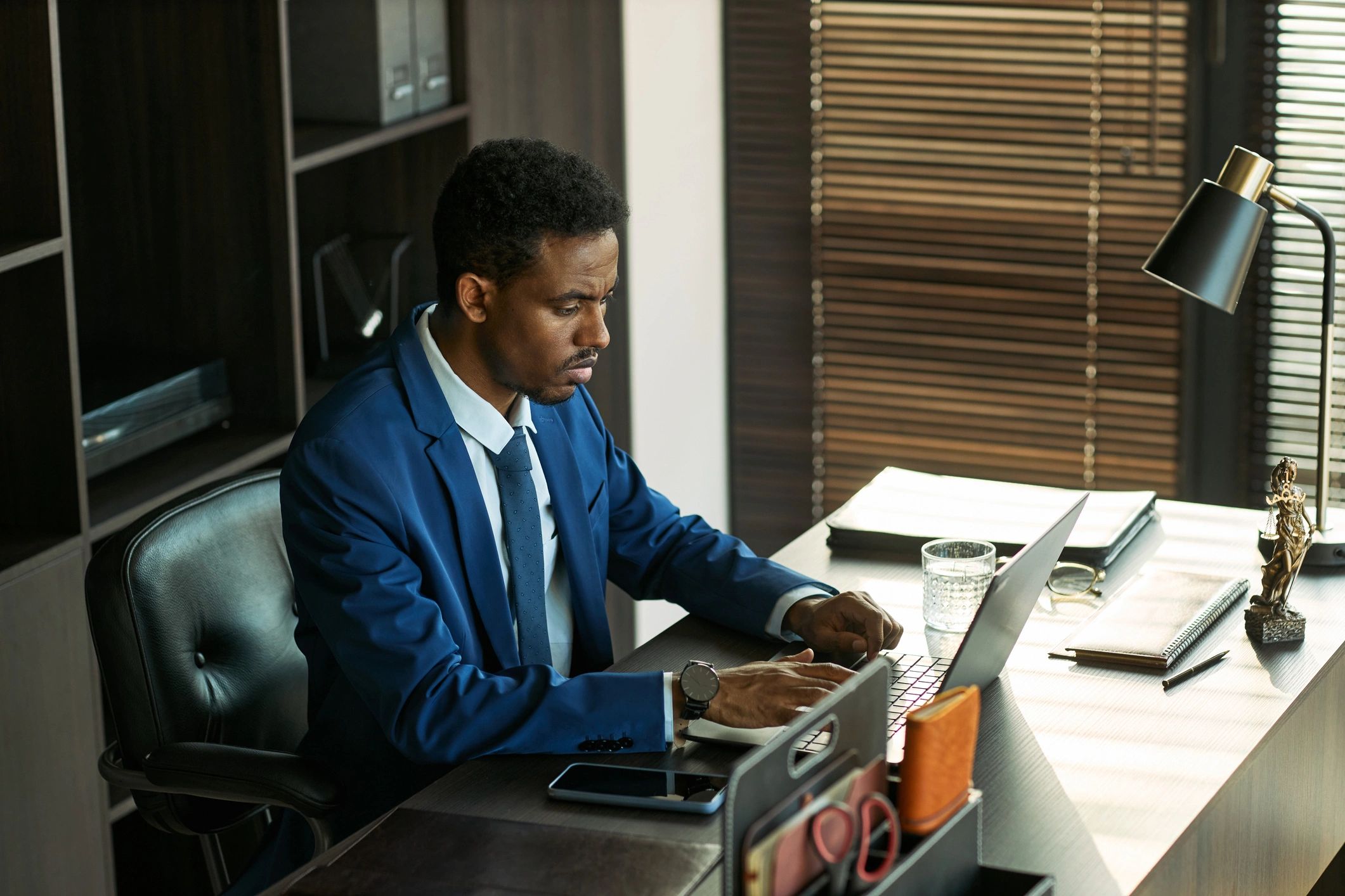 Professional planning travel details on a laptop at a desk