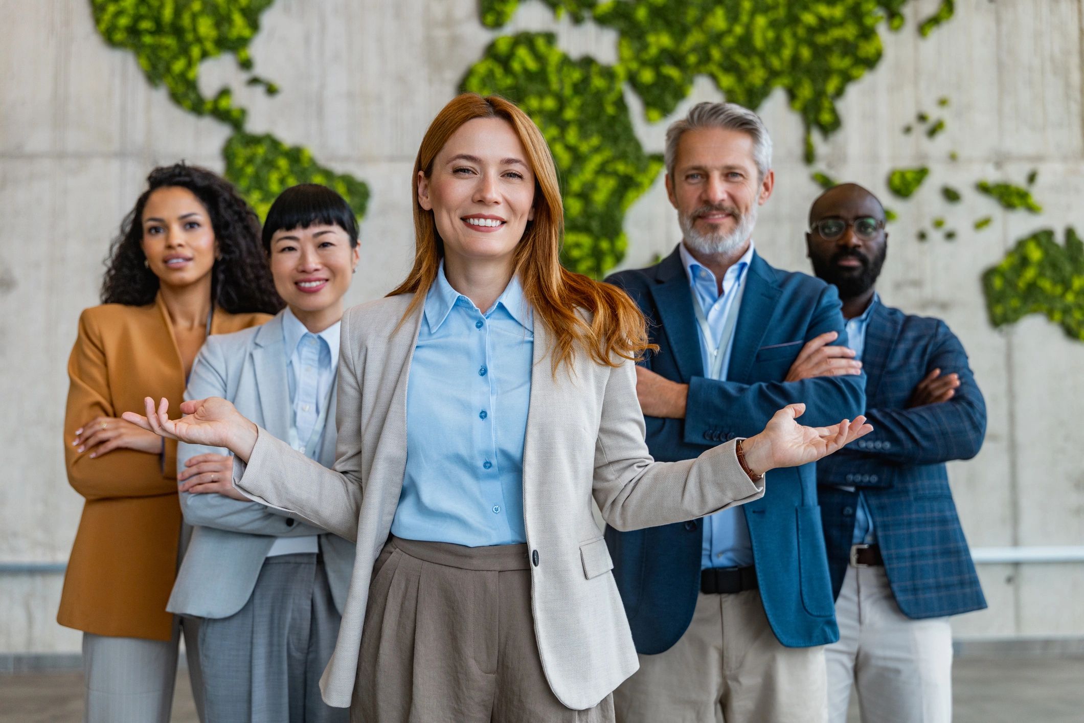 Professional travel team standing together in a modern office